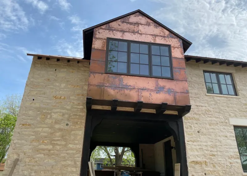 Copper metal panel facade on a stone building for Skylight Installation in Laurel